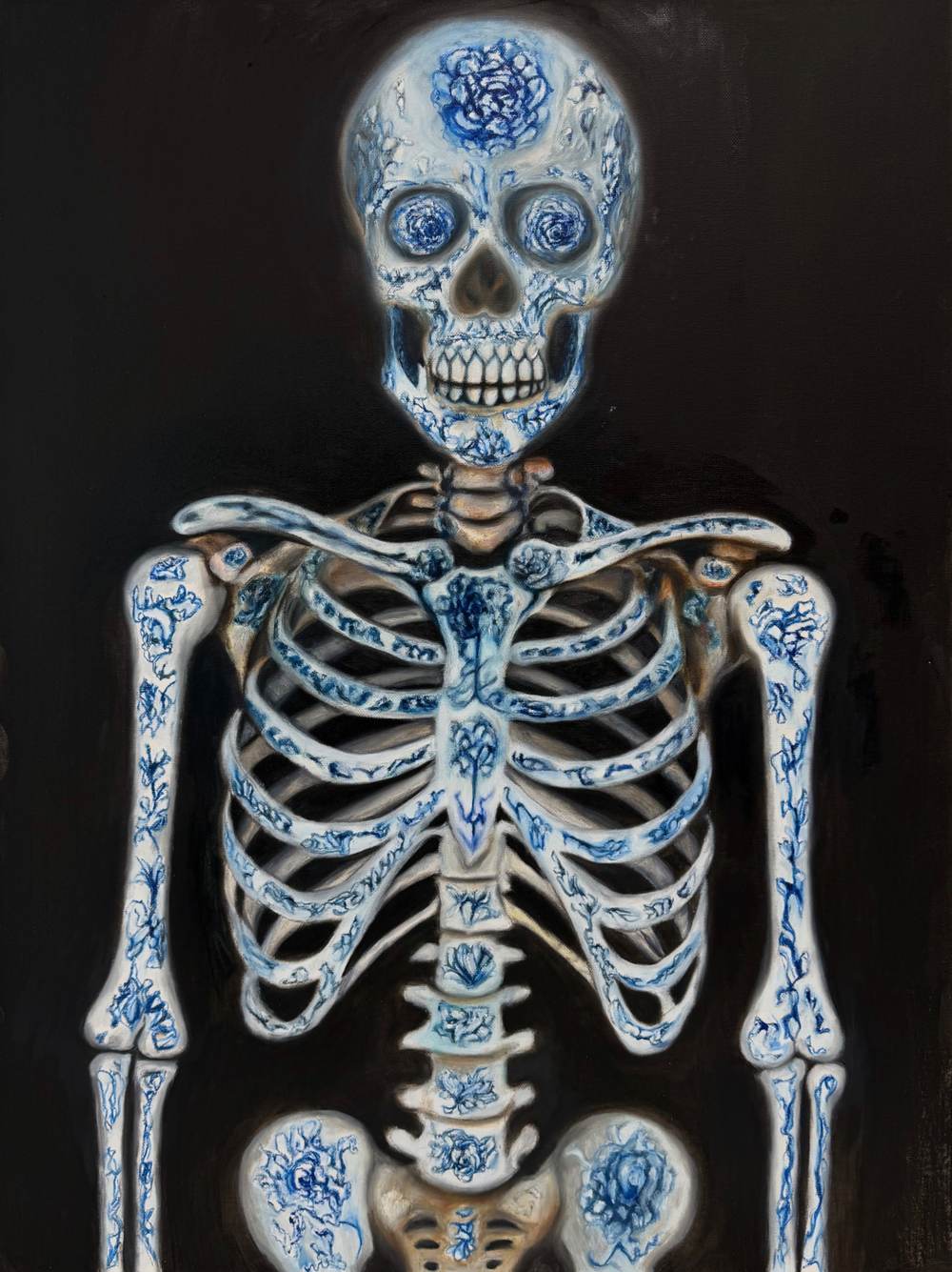 Oil painting of a human skeleton from skull to pelvis, its bones glazed like blue-and-white porcelain painted with peonies, glowing against black.